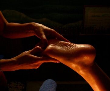 a masseuse massaging a foot