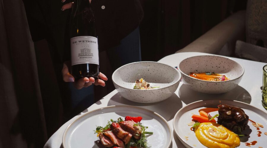 plates of food in an Amsterdam restaurant and a bottle of wine