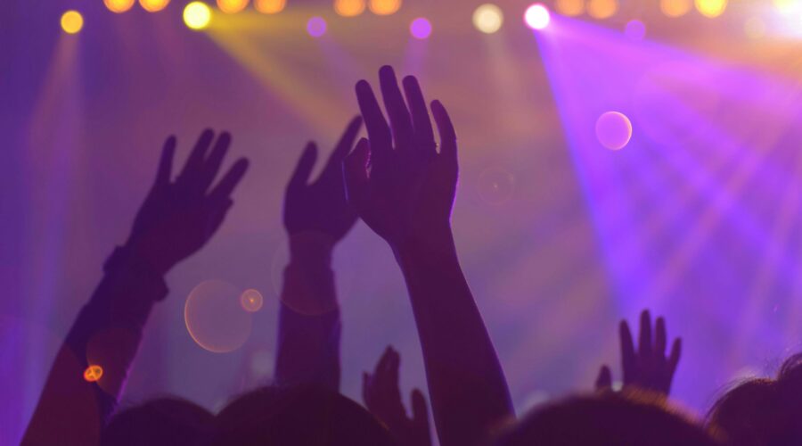 people dancing in a club in Amsterdam with purple and yellow lights