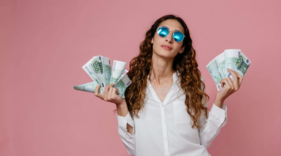 a woman holding many banknotes