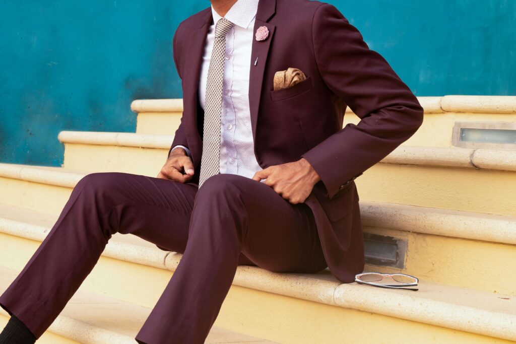 man in a burgundy suit tie and pocket square